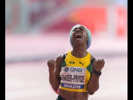 Shelly-Ann Fraser-Pryce celebrates after capturing the gold medal in the women’s 100 metres final at 2019 IAAF World Championships in Doha, Qatar, yesterday. 