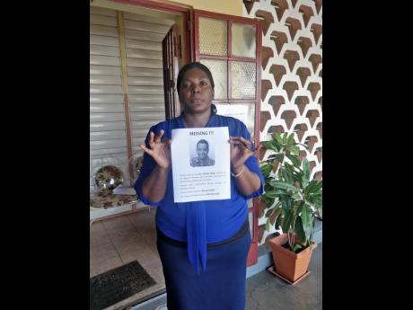 Kisha Goulbourn shows one of the flyers created by the school to help in the search for Hope.