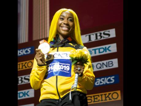 World 100 metres champion Shelly-Ann Fraer-Pryce with her gold medal after the presentation ceremony at the Khalifa International Stadium in Doha, Qatar yesterday.