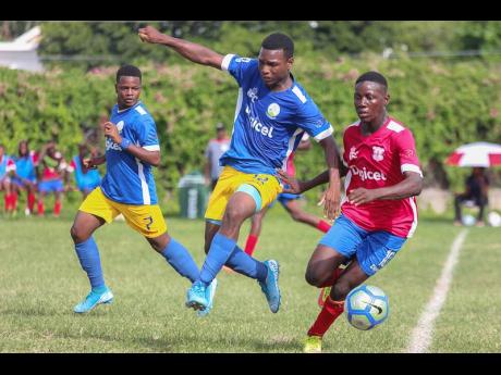 Camperdown’s Shaqueil Bradford (right) is hounded by Hydel’s Michael Thompson (centre) and Shaquise Batice during their ISSA/Digicel Manning Cup encounter at Alpha Boys Home  yesterday.