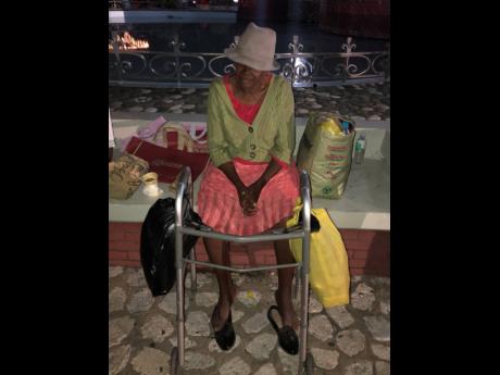 Credit: Romardo Lyons Ms Francis sits by a fountain in St William Grant Park waitng for the Christmas tree lighting to begin.