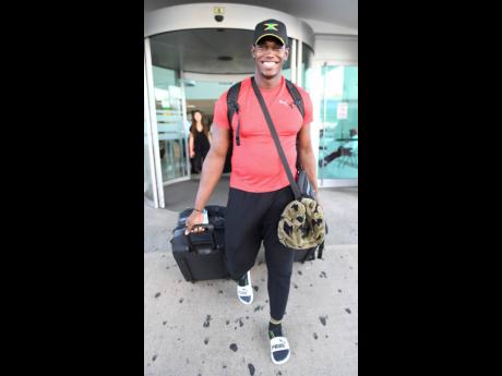 Discus throw silver medallist Fedrick Dacres  on arrival at the Norman Manley Ineternational Airport from the IAAF World Championships held in Doha, Qatar.