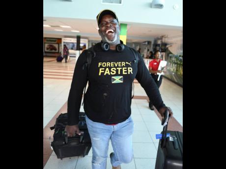 Throws coach Julian Robinson  on arrival at the Norman Manley Ineternational Airport from the IAAF World Championships held in Doha, Qatar.