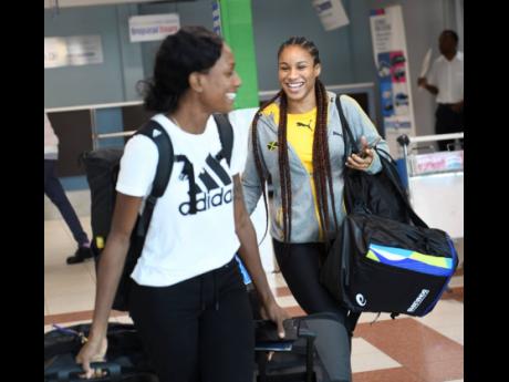Rhonda Whyte  with Briana Williams  on arrival at the Norman Manley Ineternational Airport  yesterday from the IAAF World Championships held in Doha, Qatar.