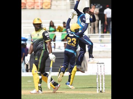 Members of the  Barbados Tridents  team celebrate the dismissal of Jamaica Tallawahs batsman Dwayne Smith during a Caribbean Premier League (CPL) match on September 15.  