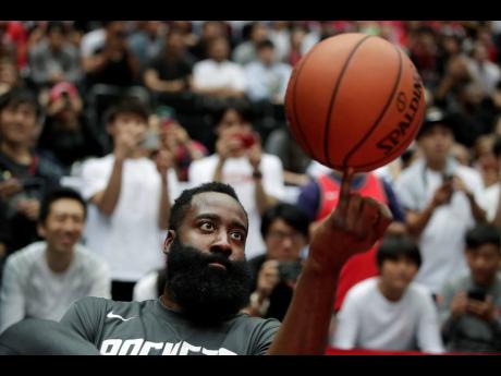 Houston Rockets’ James Harden spins the ball during warm-ups for the team’s NBA preseason basketball game against the Toronto Raptors  October. 10, 2019, in Saitama, near Tokyo.