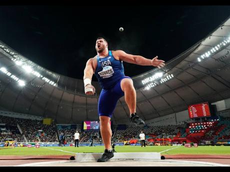 Joe Kovacs, of the United States, competes in the men’s shot put final to win the championship record for gold at the World Athletics Championships in Doha, Qatar, October. 5, 2019. 