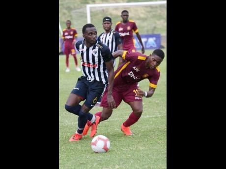 Jamaica College’s Nickache Murray (left) turns past former Wolmer’s Boys School teammate Orlando Russell during their ISSA/Digicel Manning Cup game at the Stadium East field on Monday, September 16, 2019.