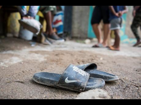 A pair of slippers worn by one of the deceased was still at the crime scene.