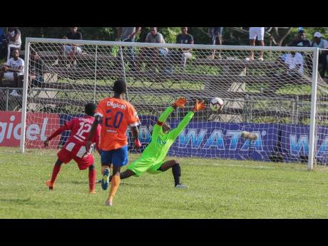 Lennon’s goalkeeper Jovaun Grant (right) makes a point blank save to deny BB Coke’s Kaymani Case (left) during their ISSA/WATA daCosta Cup second-round first-leg game at the Juici Patties Park yesterday.