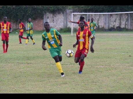 Cornwall College’s Solano Birch (right) battles Green Pond High School’s Zedford Vacciana in the ISSA/WATA daCosta Cup at Cornwall College football field on September 11, 2019.