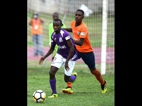 Kingston College’s Arymanya Rodgers (left) dribbles away from Dunoon Technical’s Omari Morgan during their ISSA/Digicel Manning Cup encounter at the Stadium East field on Monday, September 10, 2018.