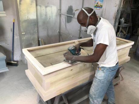 Credit: Romardo Lyons Ferron Shaw working on a coffin.
