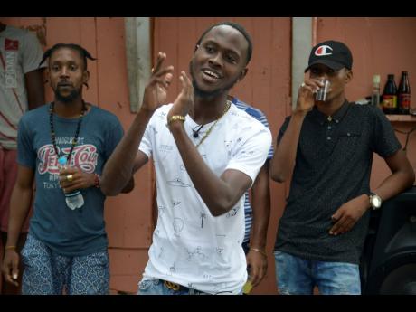 LaaLee (centre) vibing in his community.