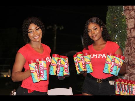 Campari ladies Sashoy Brown (left) and Vanessa McDonald were on site making sure fete-goers had their mugs ready for the fun at Xodus Carnival’s Enchanted cooler launch.