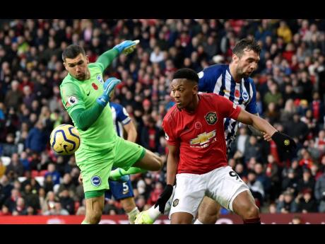 Brighton goalkeeper Mathew Ryan (left) makes a save in front of Manchester United’s Anthony Martial during their teams’ English Premier League match at the Old Trafford Stadium in Manchester, England, yesterday.