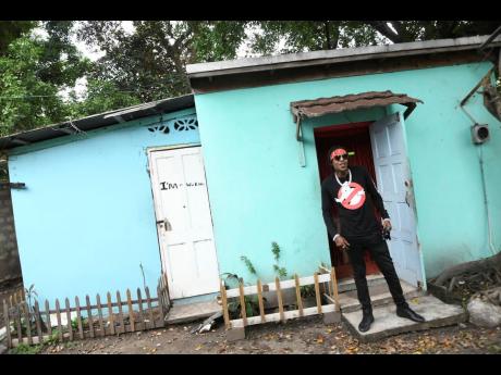 Dancehall artiste, Savage standing infront his ‘likkle blue house’