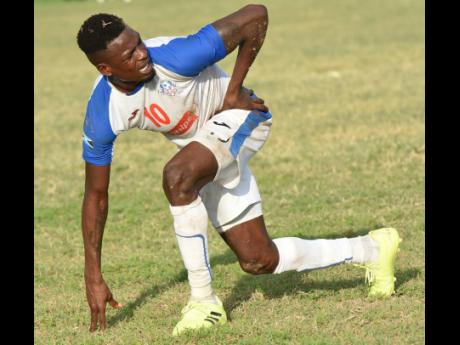 Portmore United’s Cory Burke grimaces after he was tackled by a Waterhouse player during their Red Stripe Premier League match at the Spanish Town Prison Oval on November 10, 2019.
