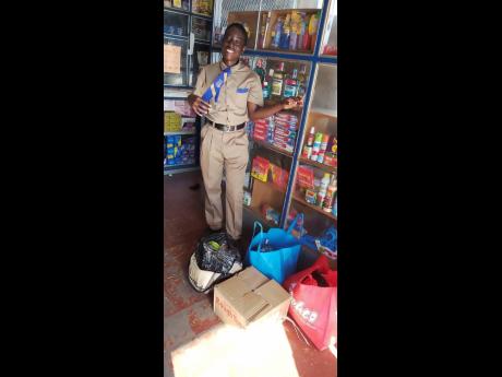 Credit: Romardo Lyons Omar Lindo with items purchased by his classmates.
