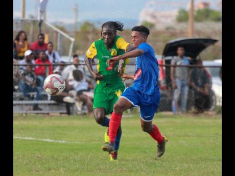 Vere United's Devroy Grey and Portmore United 's Lamar Walker chase the ball during their RSPL match in Clarendon on Sepetmber 8, 2019.