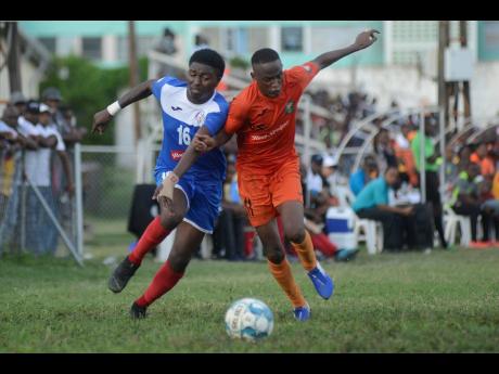 TivoliGardens’ Trayvon Reid (right) challenges Roberto Johnson of Portmore United for the ball during their RSPL match at the Edward Seaga Sports Complex yesterday.