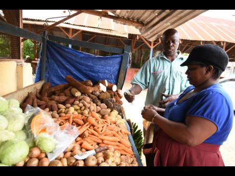 Yvette Nation (right) sells some produce to customer Pie Levy.