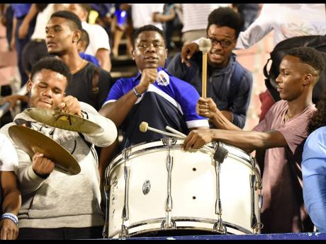 Jamaica College supporters contribute to the atmosphere at the National Stadium with their drums. 