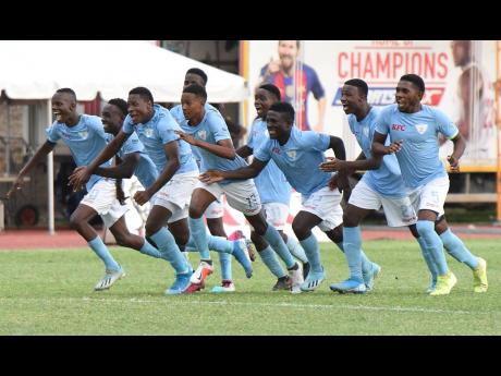 St Catherine High School footballers celebrate after defeating St George’s College on penalties in the semi-final of the Walker Cup at the Stadium East field yesterday. 