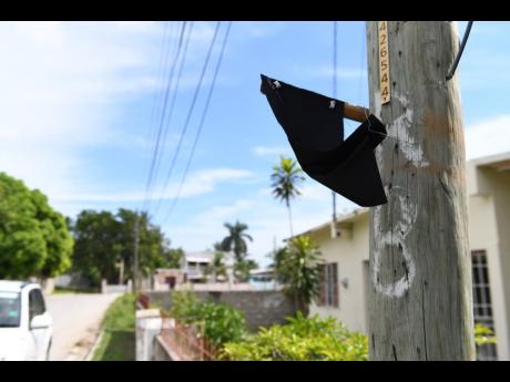 Credit: Ricardo Makyn A piece of black cloth hangs from a lightpost in memory of Abigale Rowe.