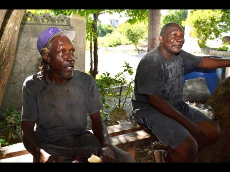 Credit: Kenyon Hemans Michael Smith (left) and Gilroy Thompson, both fishermen from Hellshire, speak about the recent crocodile attacks in the area.