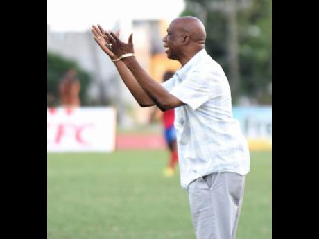 Credit: Ian Allen Leebert Halliman, coach of Excelsior High School, gesticulates to his players during their Walker Cup semi-final football match against Camperdown High on November 21, 2019.