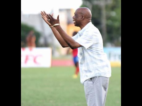 Leebert Halliman, coach of Excelsior High School, gesticulates to his players during their Walker Cup semi-final football match against Camperdown High  on November 21, 2019.