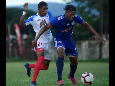 Mount Pleasant’s SueLae McCalla (right) shields the ball from Portmore United attacker Courtney Allen in their RSPL encounter at the Spanish Town Oval on Sunday, November 24, 2019.
