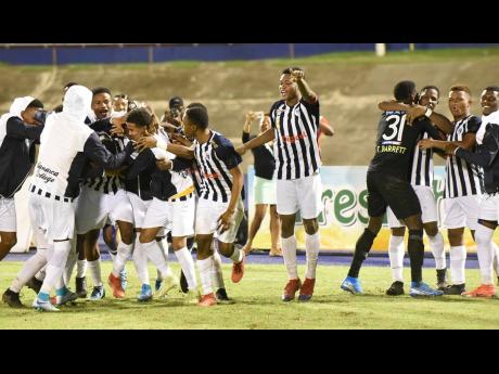 Jamaica College football players celebrate after they beat Kingston College on penalties in the semi-final of the ISSA/Digicel Manning Cup semi-final on November 20, 2019. 