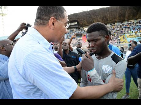 Credit: Ian Allen Prime Minister Andrew Holness congratulates St Catherine High School goalkeeper, Raheem Henry, after the St John’s Road-based school beat Excelsior High School 3-2 in the Walker Cup final last Friday, November 29, 2019.