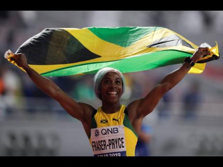 Shelly-Ann Fraser-Pryce celebrates after winning the gold medal in the women’s 100 metres final at the World Athletics Championships in Doha, Qatar, on September 29, 2019. 
