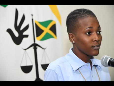 Moya Blackwood speaks to members of the media during  the Jamaicans For Justice press briefing on incarcerated children at the Spanish Court Hotel yesterday.