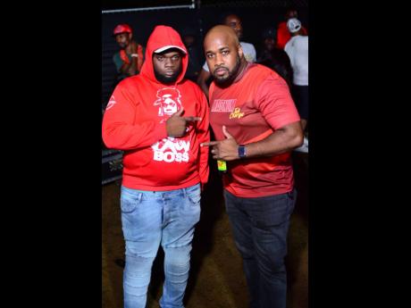 Recording artiste Chronic Law (left) and Mark Telfer, brand manager, 
J. Wray and Nephew LImited, are caught on camera  at the Magnum Big 20 Party at Addison Park, Brown’s Town, last Friday.