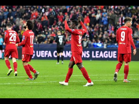 Liverpool's Naby Keita, centre, celebrates after scoring his side's opening goal during the group E Champions League match between Salzburg and Liverpool yesterday.