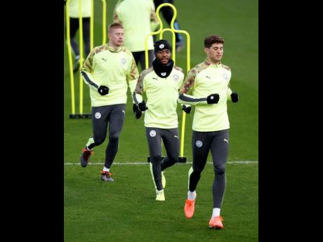 Manchester City’s Kevin De Bruyne, Raheem Sterling (centre), and John Stones (right) during a team training session at the City Football Academy in Manchester, England, on Monday, November 25, 2019. 
