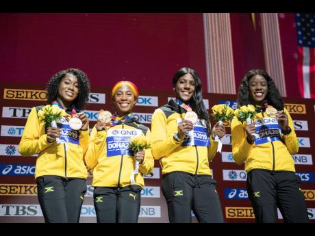 Members of Jamaica’s female sprint relay team pose with their gold  medals after winning the event at the World Athletics Championships in Doha, Qatar. From left: Natalliah Whyte, Shelly-Ann Fraser-Pryce, Jonielle Smith and Shericka Jackson.  