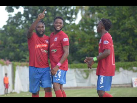 Credit: Shorn Hector Dunbeholden’s goalscorer Dean-Andre Thomas (centre) celebrates with teammates André McFarlane (left) and Demario Phillips during their game against UWI FC in the Red Stripe Premier League at Royal Lakes in St Catherine on Sunday.