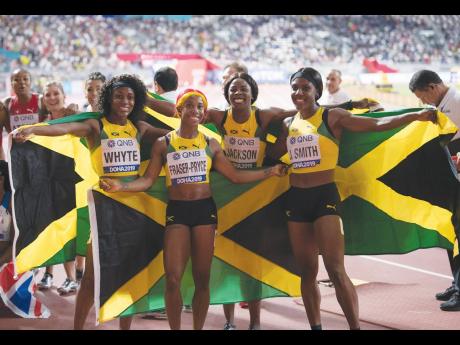 From left: Natalliah Whyte, Shelly-Ann Fraser-Pryce, Shericka Jackson, and Jonielle Smith moments after victory in the women's 4x100m relay final at the World Athletics Championships at the Khalifa International Stadium in Doha, Qatar on Saturday, October 5, 2019.