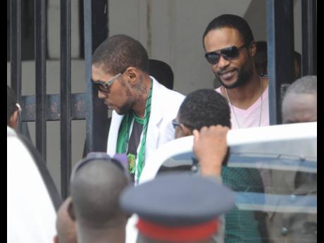 Entertainers Vybz Kartel (left) and Shawn Storm leave the Home Circuit Court, where they were sentenced to life imprisonment in 2014.