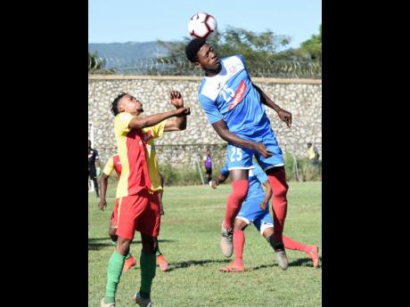 Humble Lion’s Mark Rodney (left) is outjumped by Portmore United’s Shai Smith (right) during their Red Stripe Premier League match which was played at the Spanish Town Prison Oval on Sunday.