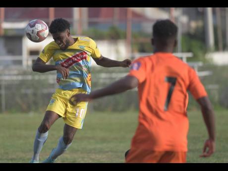 Waterhouse player Kenroy Howell (left)  heads the ball away while Tivoli’s Junior McGregor looks on in their Red Stripe Premier League encounter at the Edward Seaga Complex on Thursday, December 19, 2019.
