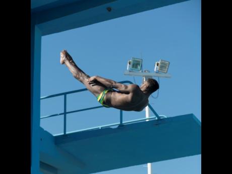 Knight-Wisdom midair after leaping off the diving platform at the National Aquatic Centre in Kingston on Thursday.
