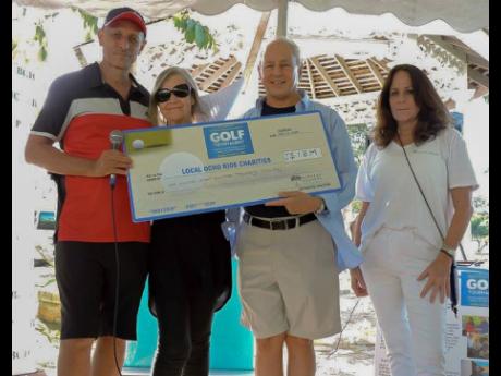 From left:  Glenn Lawrence, CEO of Couples Resorts; Maureen Sheridan, director of Animal House; Paul Issa, deputy chairman of Couples Resorts and Alex Ghisays, Group PR Director of Couples, pose with the ceremonial cheque following the resorts Charity Golf Tournament in Ocho Rios.