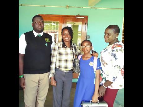Kimani Nunis (left) is joined by (from second left) Jennifer Jarret, guidance counsellor at Calabar High School, Destiny Morrison and Winsome Blair.