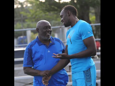 Usain Bolt (right) with his former coach coach Glen Mills.